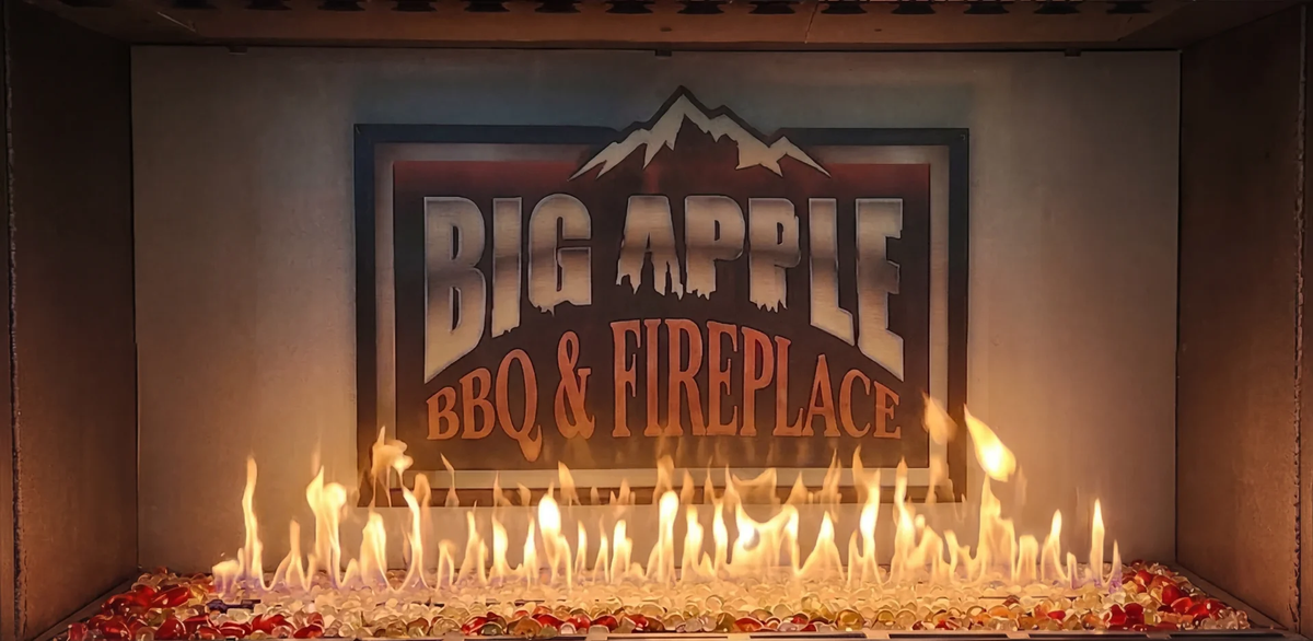 A lit gas fireplace beneath the Big Apple BBQ & Fireplace sign