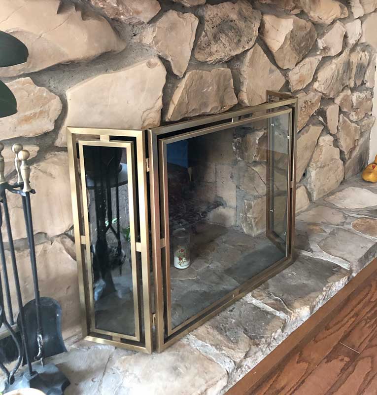 Floating Glass Folding Fireplace Screen, shown in a room setting