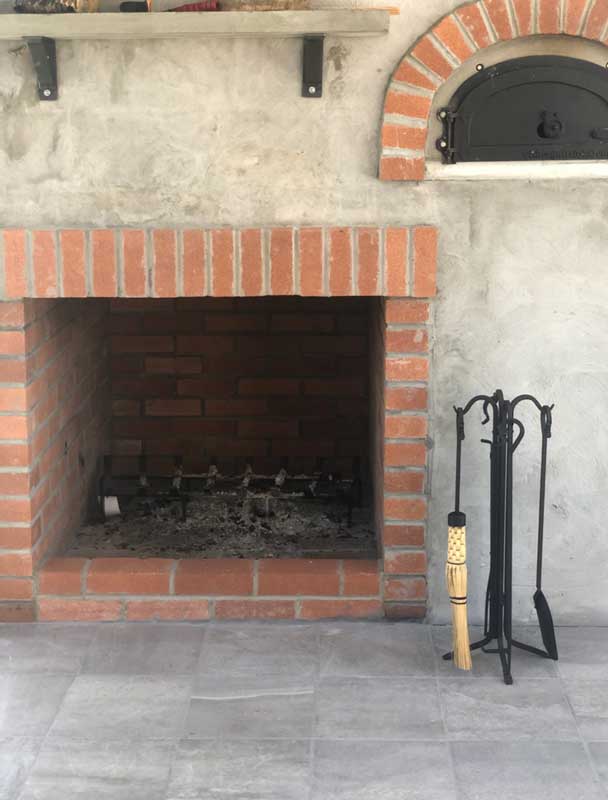 Forged Hearth Tool Set with Corn Broom, shown in a room setting