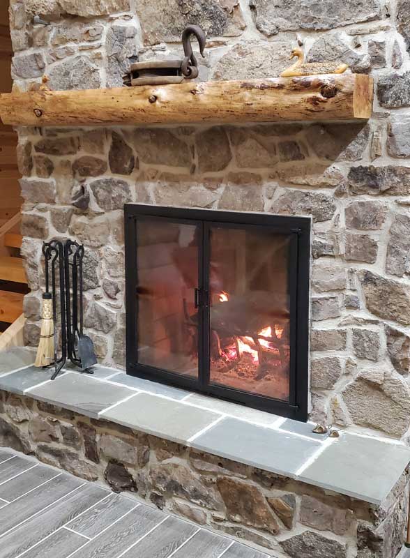 Forged Hearth Tool Set with Corn Broom, shown in a room setting