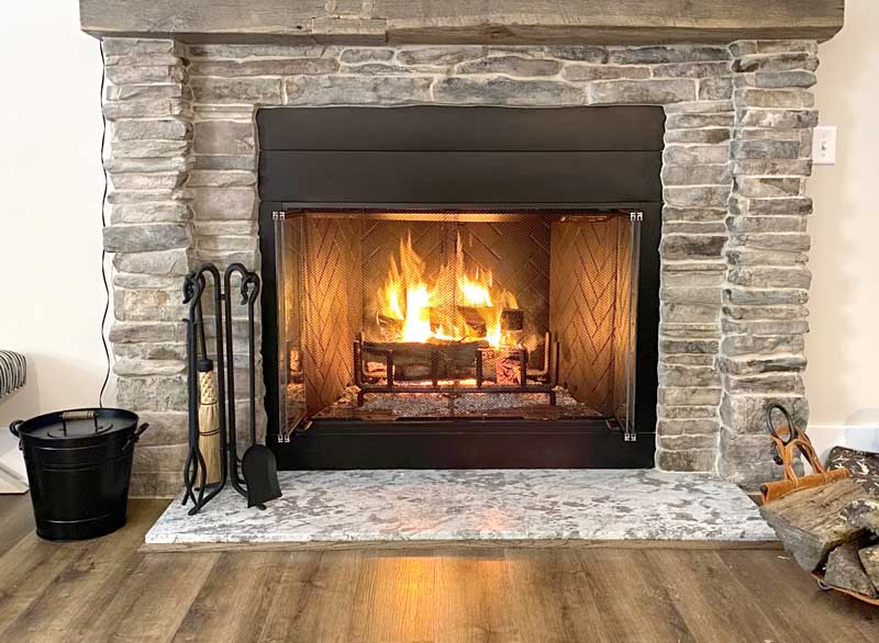 Forged Hearth Tool Set with Corn Broom, shown in a room setting