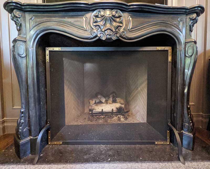 Refined Rivet Mesh Single-Panel Fireplace Screen, shown in a room setting