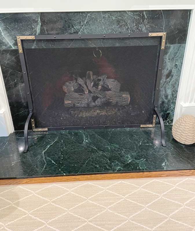 Refined Rivet Mesh Single-Panel Fireplace Screen, shown in a room setting